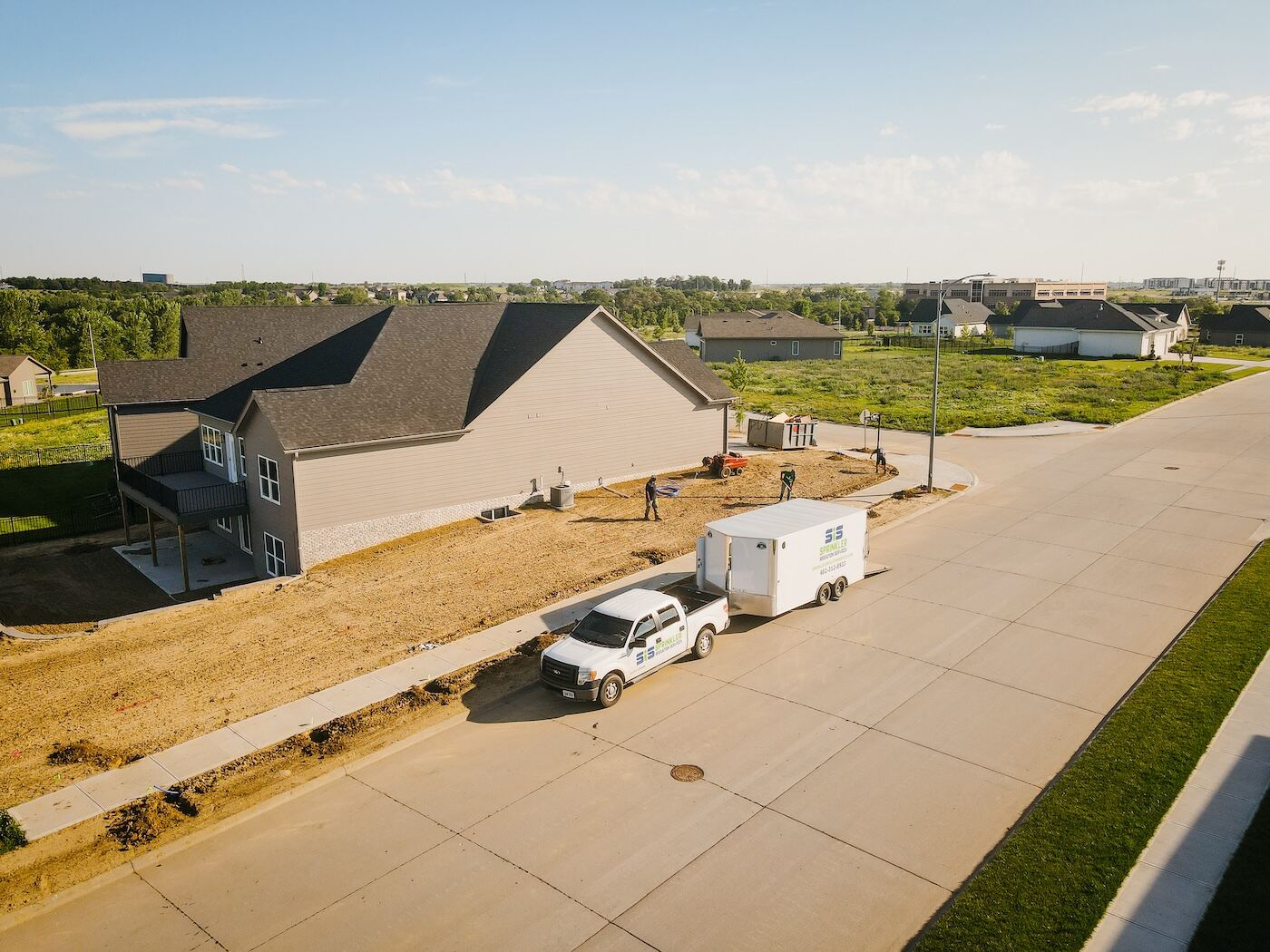 SIS crew truck and trailer at a new-construction irrigation install in Omaha